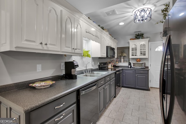 kitchen featuring a sink, white cabinetry, appliances with stainless steel finishes, gray cabinets, and dark countertops