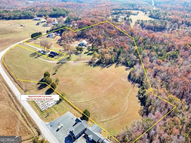 birds eye view of property featuring a rural view