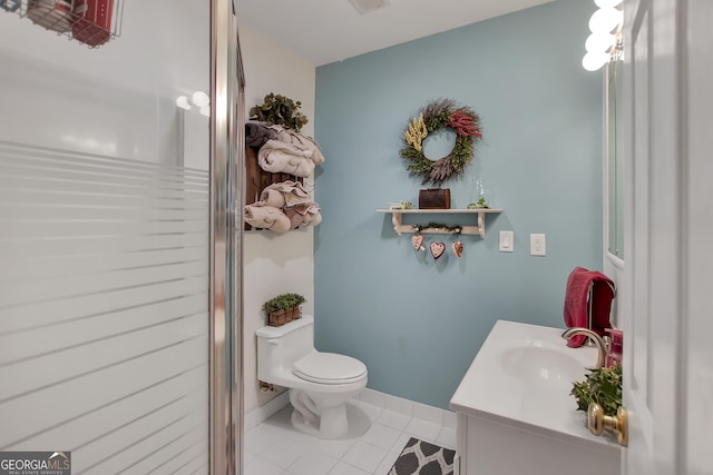 bathroom featuring baseboards, toilet, tile patterned flooring, an enclosed shower, and vanity