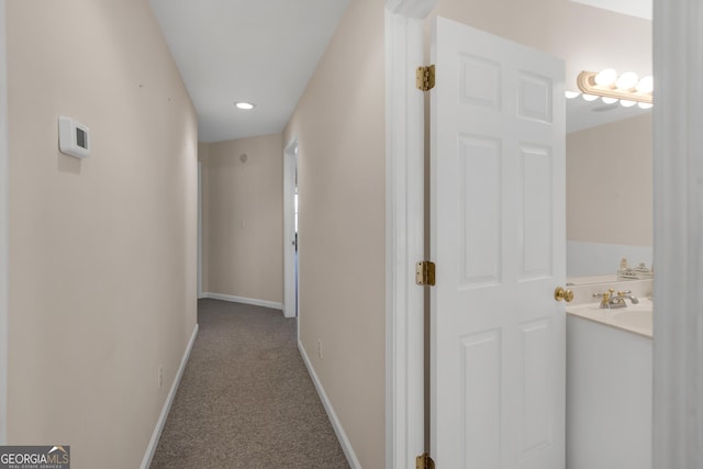hall with carpet floors and baseboards