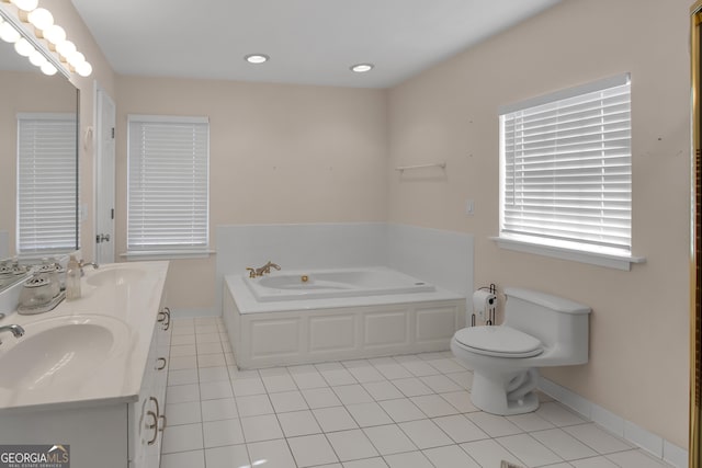 bathroom featuring toilet, vanity, a tub to relax in, and tile patterned floors