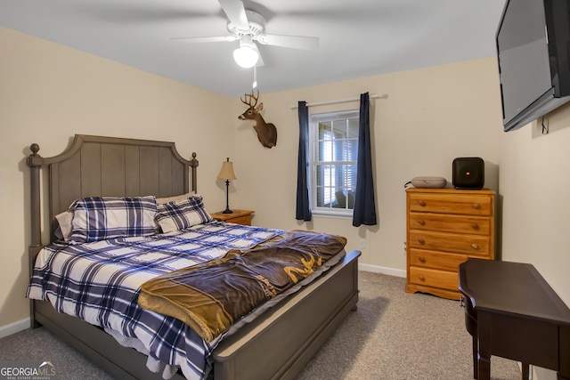 carpeted bedroom featuring ceiling fan and baseboards