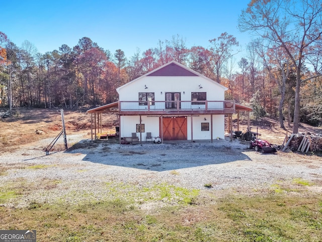 back of house with a deck