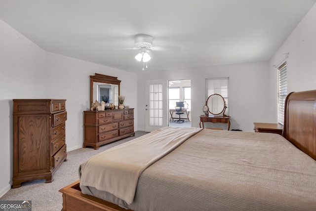bedroom with light carpet, ceiling fan, and baseboards