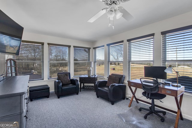 carpeted office with ceiling fan and baseboards