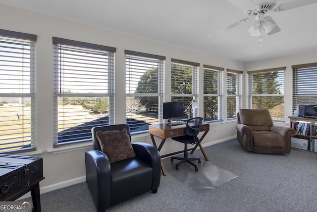 carpeted office with ceiling fan and baseboards