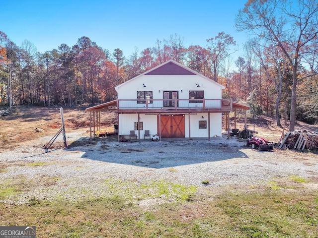 back of house featuring a wooden deck