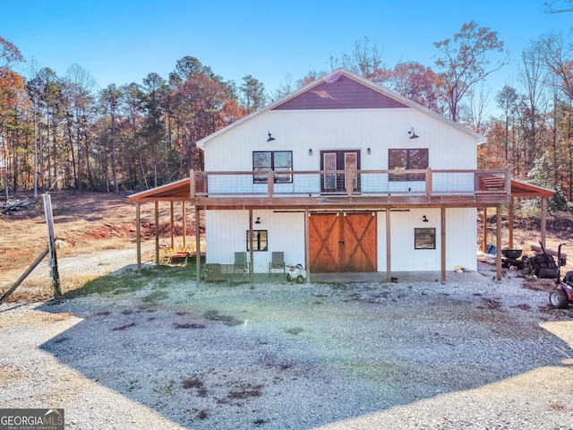 back of property with a wooden deck