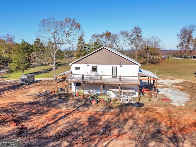 rear view of house featuring a wooden deck