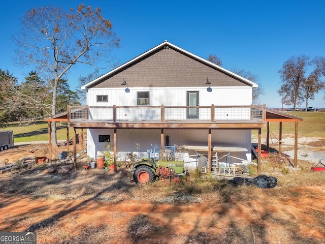 rear view of house featuring a wooden deck