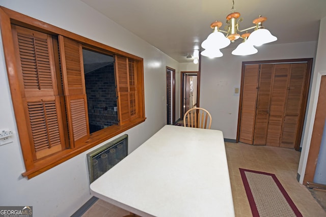 dining space with radiator heating unit and an inviting chandelier