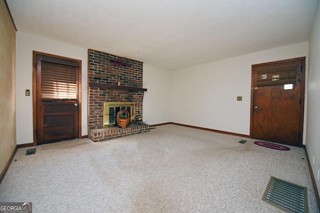 unfurnished living room with carpet and a brick fireplace