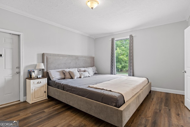 bedroom with dark hardwood / wood-style floors, crown molding, and a textured ceiling