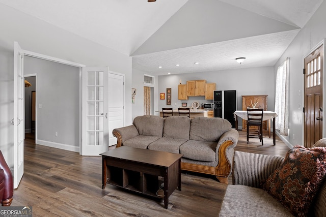 living room featuring french doors, high vaulted ceiling, and dark wood-type flooring