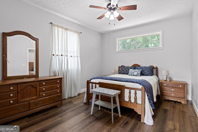 bedroom featuring a textured ceiling, dark hardwood / wood-style flooring, and ceiling fan