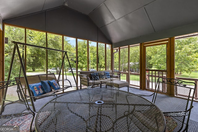 unfurnished sunroom with plenty of natural light and vaulted ceiling