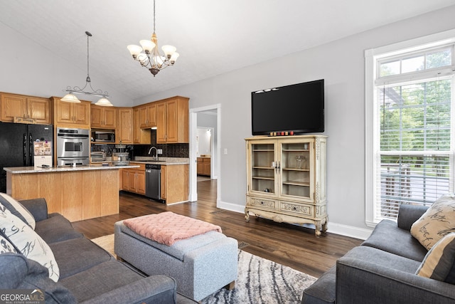 living room with sink, high vaulted ceiling, dark wood-type flooring, and a notable chandelier