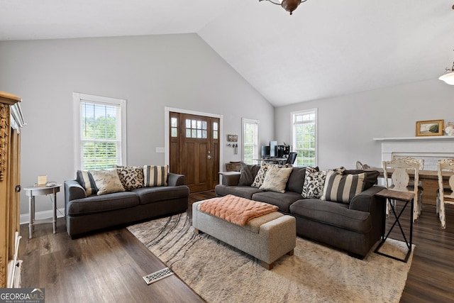 living room featuring dark wood-type flooring and high vaulted ceiling