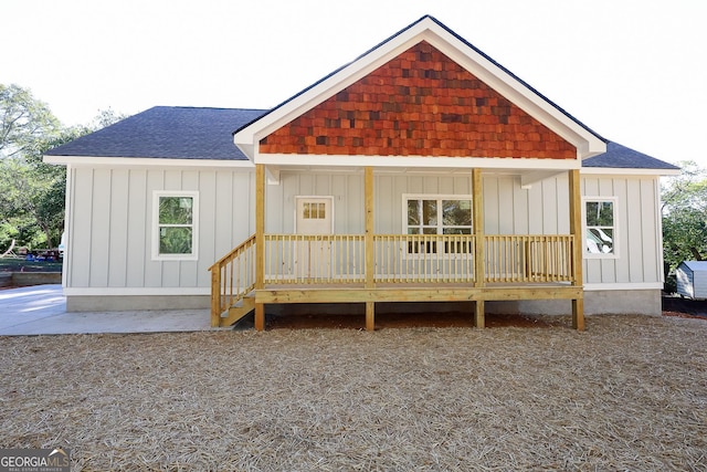 rear view of property with covered porch