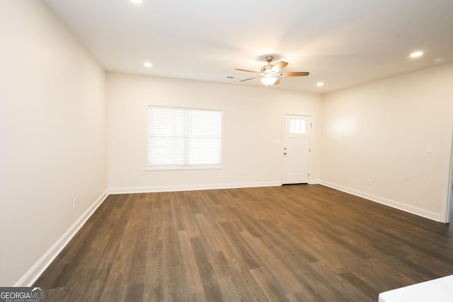 unfurnished room featuring dark hardwood / wood-style flooring and ceiling fan