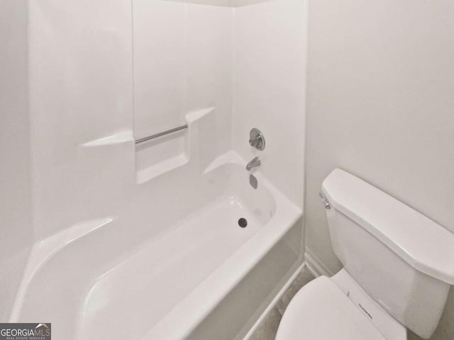 bathroom featuring bathing tub / shower combination and toilet