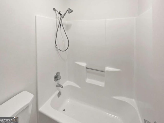 bathroom with toilet and tub / shower combination