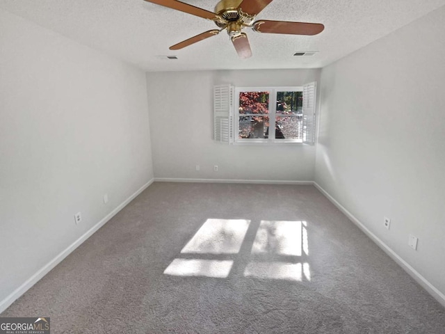 unfurnished room with a textured ceiling, carpet floors, and ceiling fan