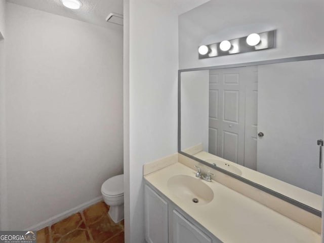 bathroom with tile patterned floors, vanity, and toilet