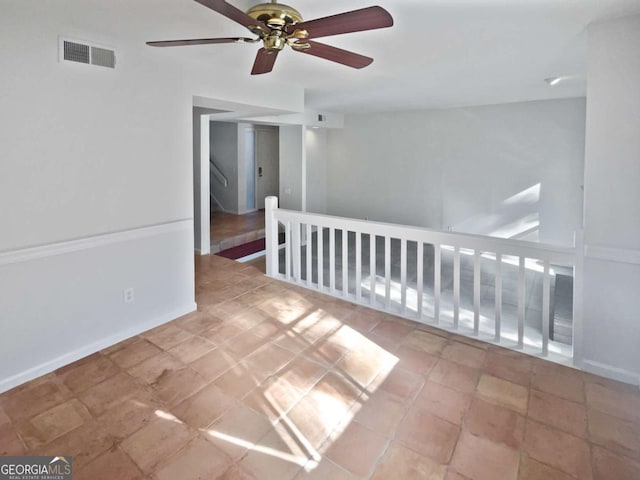 unfurnished room with ceiling fan