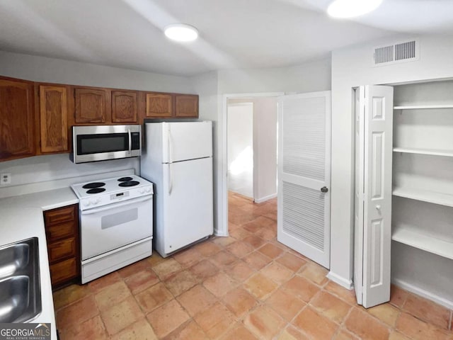 kitchen with white appliances and sink