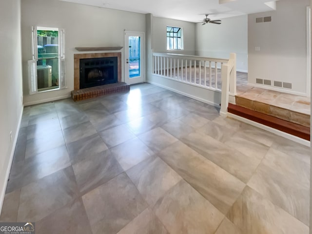 2007 Variations Dr NE, Atlanta, GA 30329 - unfurnished living room with a ceiling fan and a fireplace with raised hearth