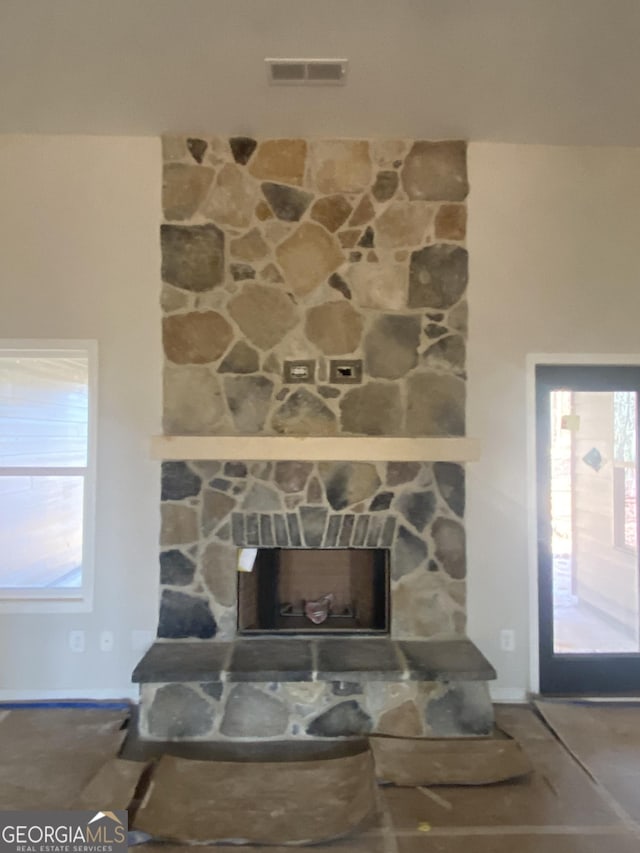 interior details featuring a stone fireplace