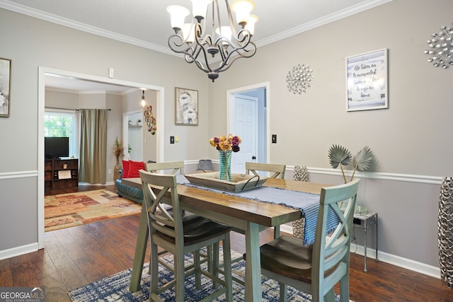 dining space with crown molding, a chandelier, and dark hardwood / wood-style floors