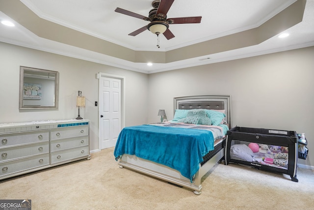 bedroom with a raised ceiling, crown molding, and ceiling fan