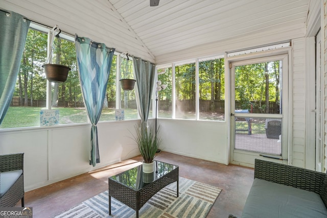 sunroom featuring plenty of natural light and lofted ceiling