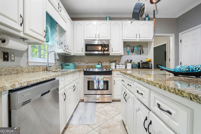 kitchen featuring stainless steel appliances, white cabinetry, ornamental molding, and sink