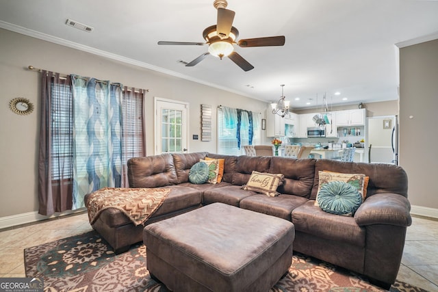 living room with ceiling fan with notable chandelier, crown molding, and light tile patterned flooring