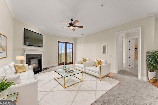 living room featuring ornamental molding, light carpet, and ceiling fan