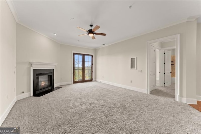 unfurnished living room featuring crown molding, light colored carpet, and ceiling fan