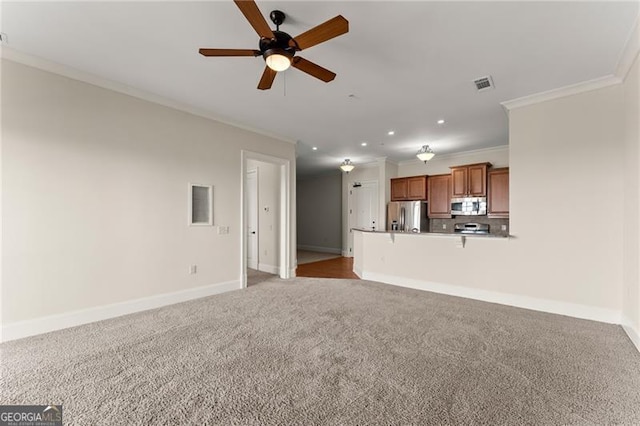 unfurnished living room with crown molding, ceiling fan, and carpet flooring