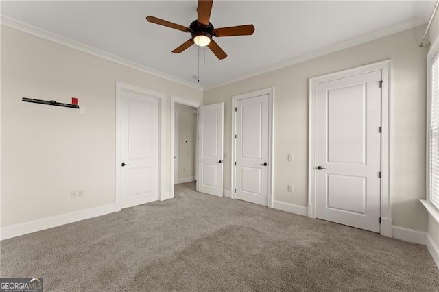 unfurnished bedroom featuring light colored carpet, ornamental molding, and ceiling fan