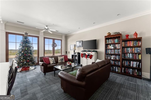 carpeted living room featuring crown molding and ceiling fan