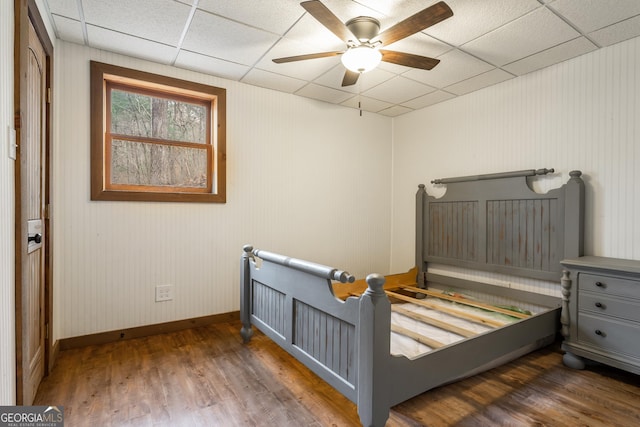 bedroom featuring a paneled ceiling, ceiling fan, and dark wood-type flooring