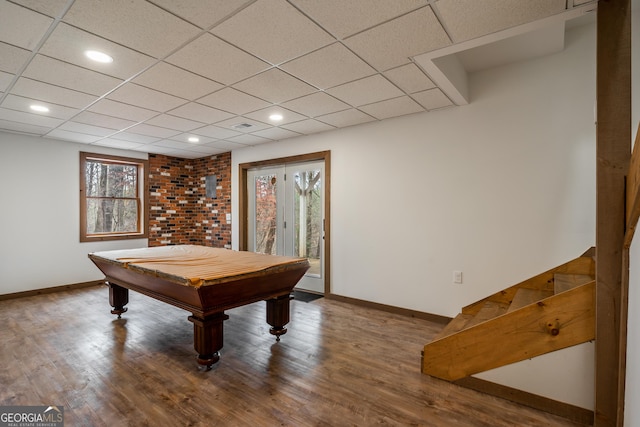 game room with a paneled ceiling, billiards, a healthy amount of sunlight, and hardwood / wood-style flooring