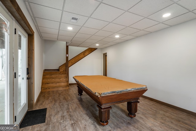 recreation room featuring a wealth of natural light, a drop ceiling, and wood-type flooring