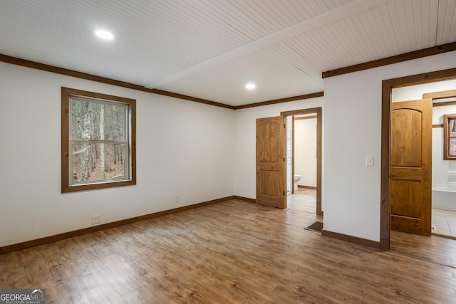 spare room featuring wood-type flooring and wooden ceiling