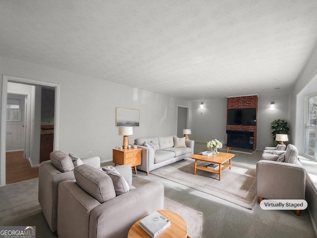 living room featuring a textured ceiling and a brick fireplace