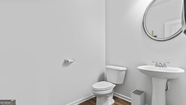 bathroom featuring hardwood / wood-style floors and toilet