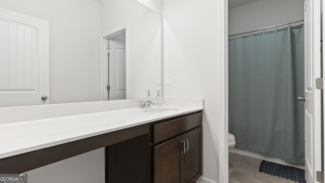 bathroom with tile patterned flooring, vanity, curtained shower, and toilet