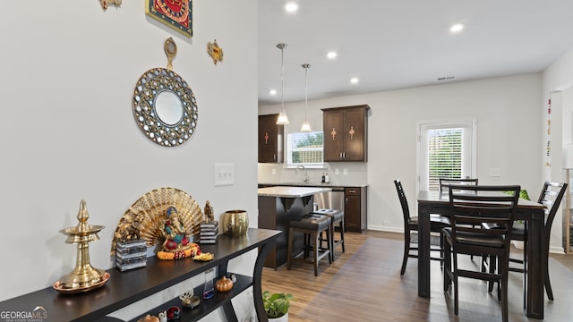 dining room featuring plenty of natural light and dark hardwood / wood-style flooring